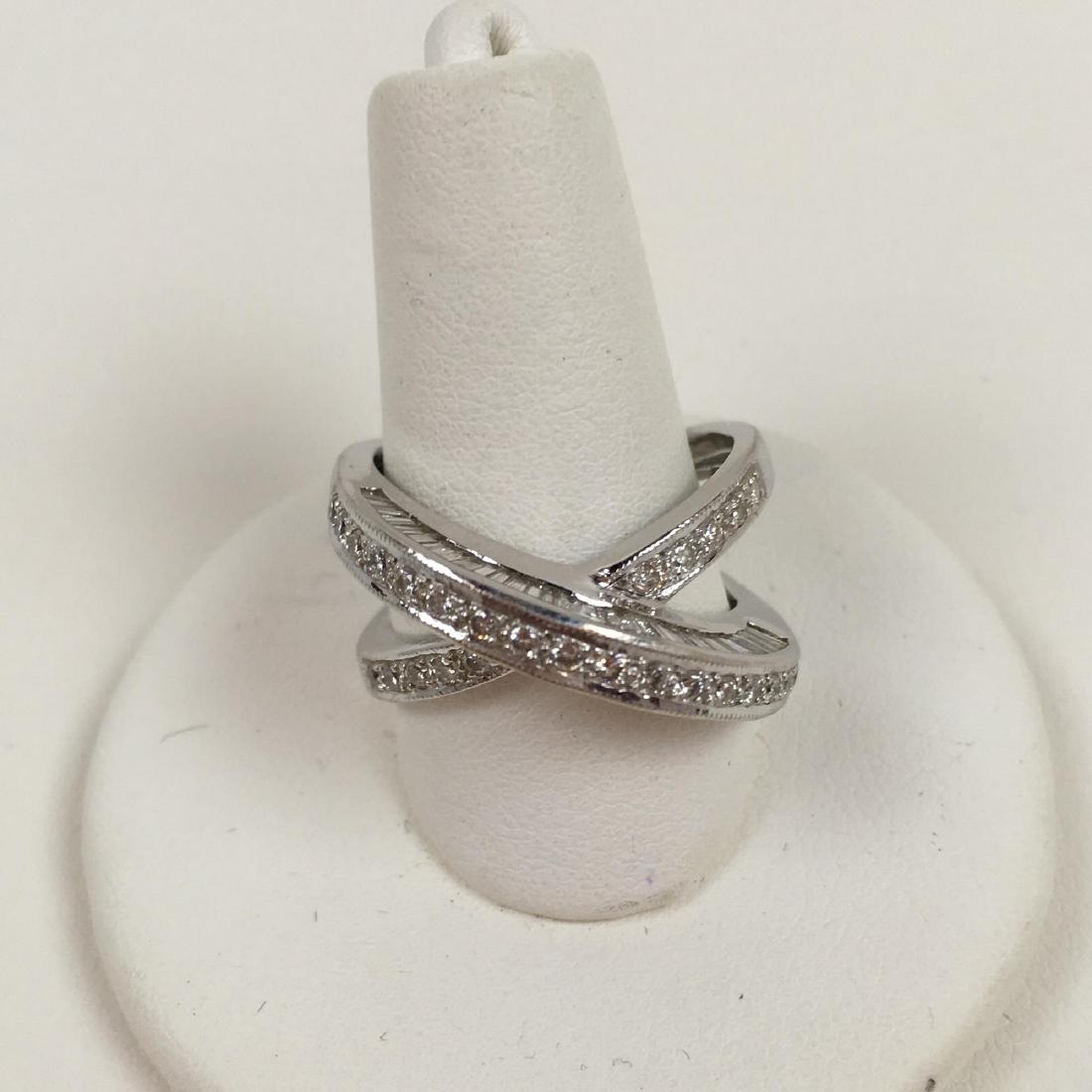 18K WHITE GOLD AND DIAMOND CRISSCROSS RING: 18 karat white gold and diamond crisscross ring 28 small inset diamonds with diamonds around the side of each band size 6.75 8 g