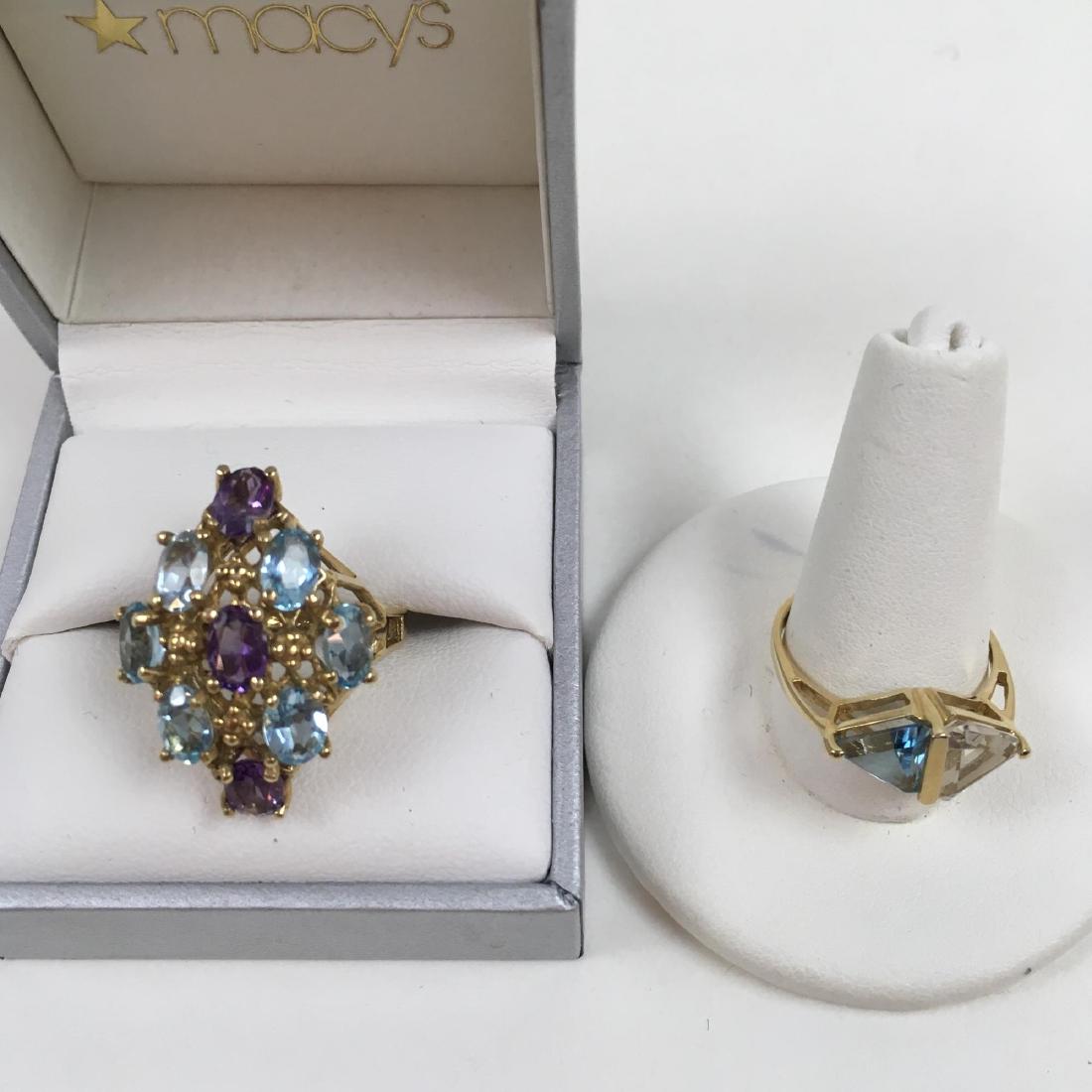 TWO 10K YELLOW GOLD RINGS: Two 10 karat yellow gold rings - blue topaz and amethyst size 7.5 6 g and a topaz size 7.5 2 g