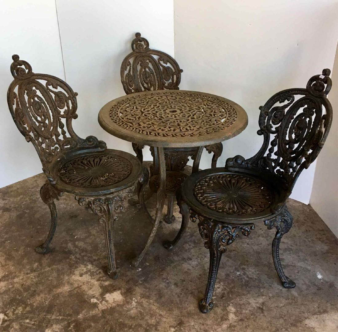 CAST IRON TABLE AND 3 CHAIRS: Table - 24" diameter x 23" - chairs 31" tall - shipping will be costly due to size / weight, please get a third party shipping estimate before bidding