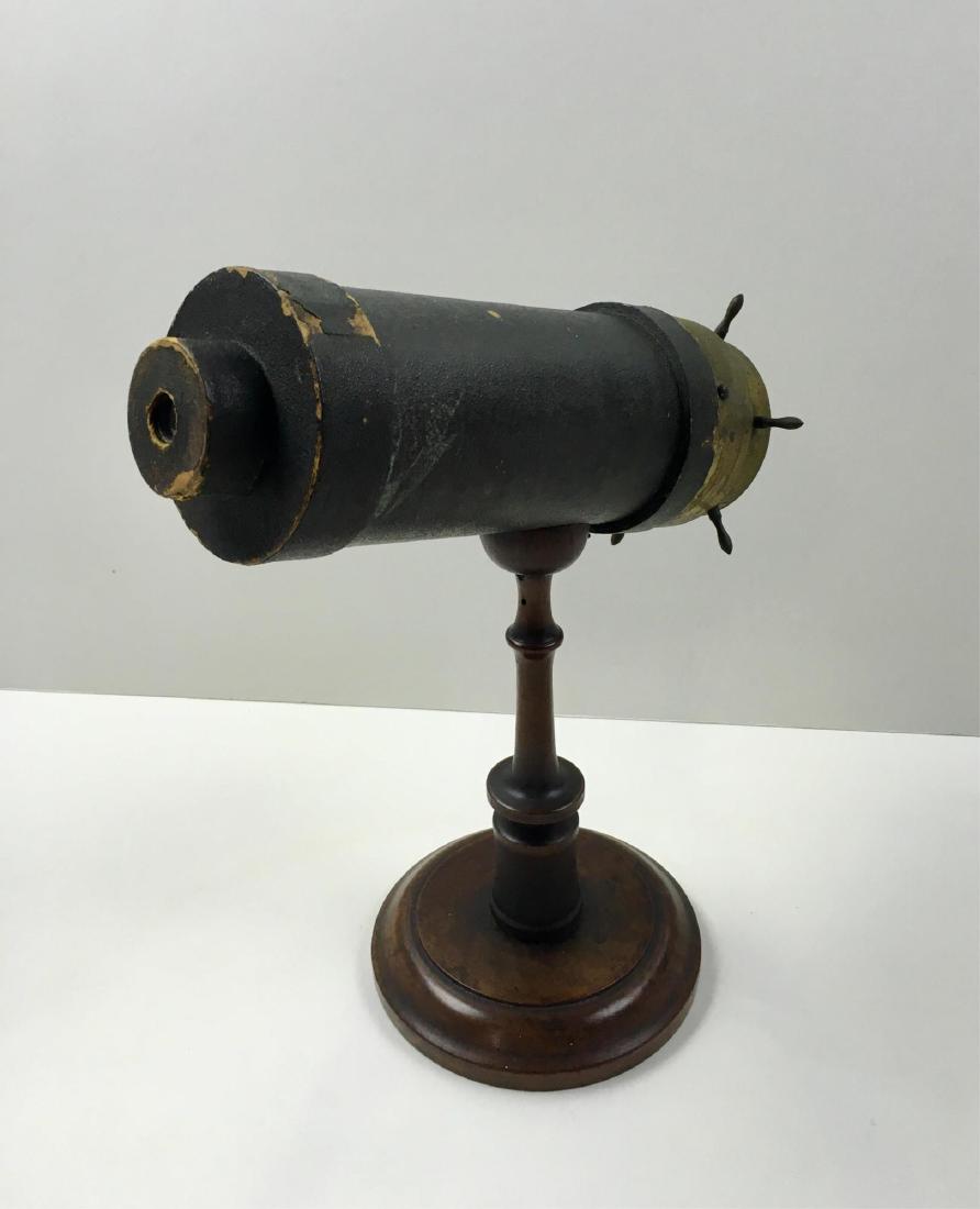 ANTIQUE KALEIDOSCOPE BY CHARLES BUSH: Circa 1875 by Charles Bush - marked on bottom 1875 - 9.5" attached turned mahogany pedestal - scope is 10.25" long, 3.5" diameter - cardboard tube with brass end and brass ship's wheel turning mechani