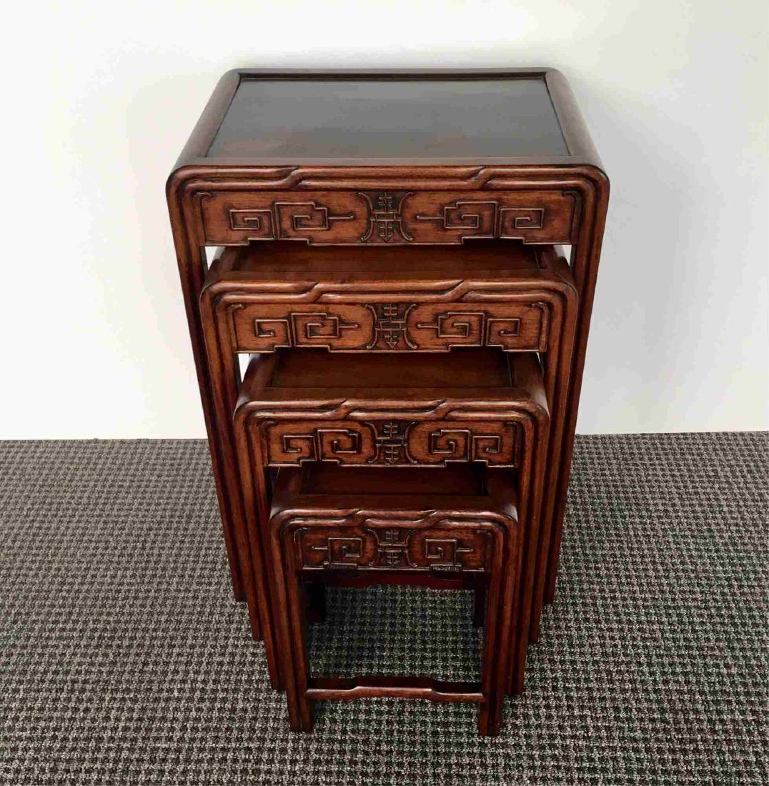 SET OF FOUR CHINESE NESTING TABLES: Set of four carved Chinese nesting tables - largest measures 18.25" x 13.75" x 27.5" to the smallest 11" x 8.25" x 16"