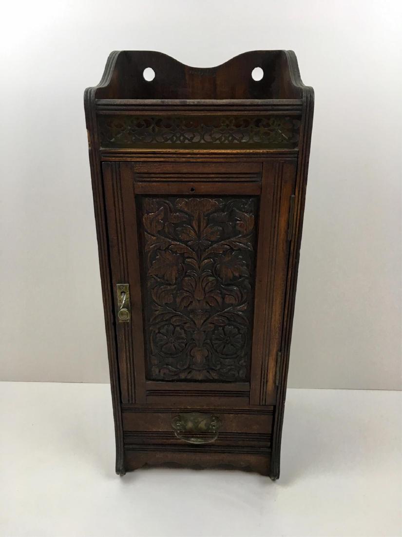 ANTIQUE CARVED ENGLISH OAK WALL CABINET: Brass gallery at top, carved door cabinet with interior drawer, 1 exterior drawer - Rd No. 9215649 - 8.5" x 7.25" x 20.25" - top has split above hanging hole