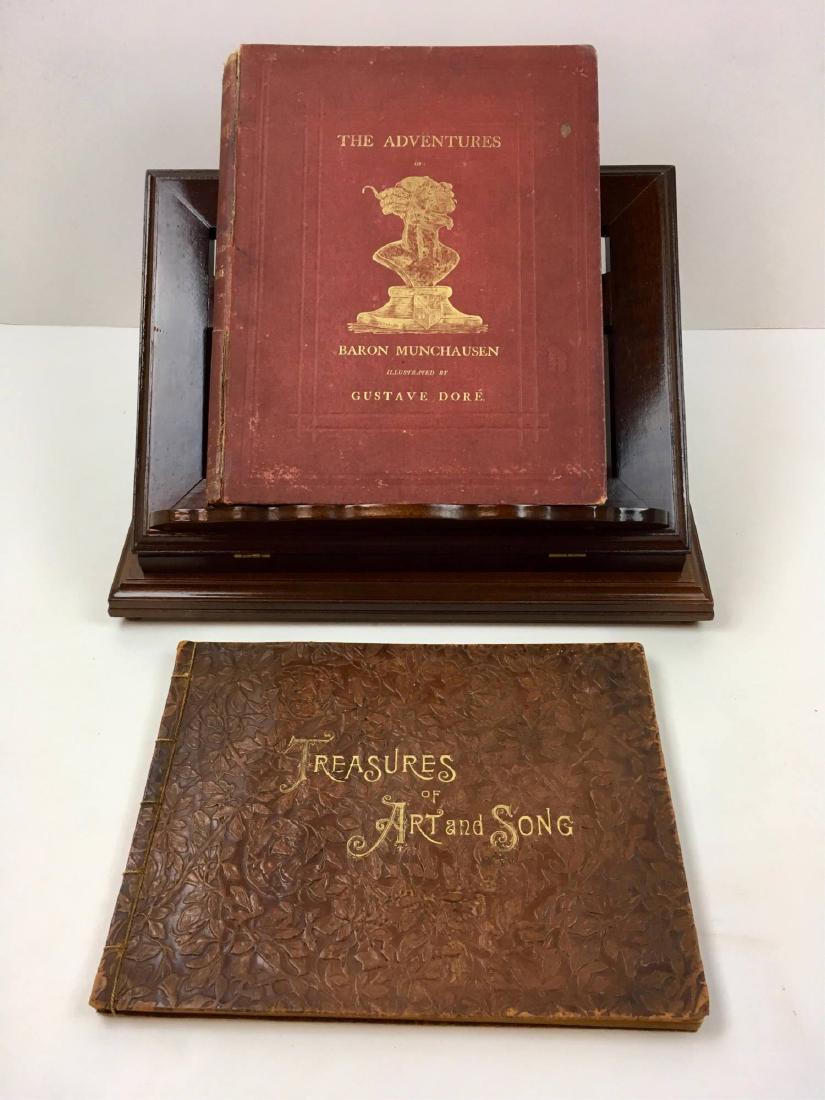 FOLDING BOOK STAND & 2 ANTIQUE BOOKS: Bombay Co. folding wooden book stand 17" x 13" x 4.75" closed or 10" open plus 2 antique books - "The Adventures of Baron Munchausen" illustrated by Gustave Dore and a tooled leather bound "Treasures
