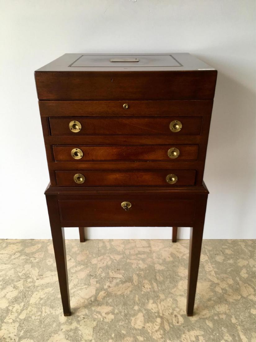MAHOGANY SILVER CHEST ON STAND: 2 piece construction - Hepplewhite style - brass hardware - lift off chest has hinged lift top over 3 drawers with silver cloth fitted interior - stand base has a single drawer - brass plaque on top w