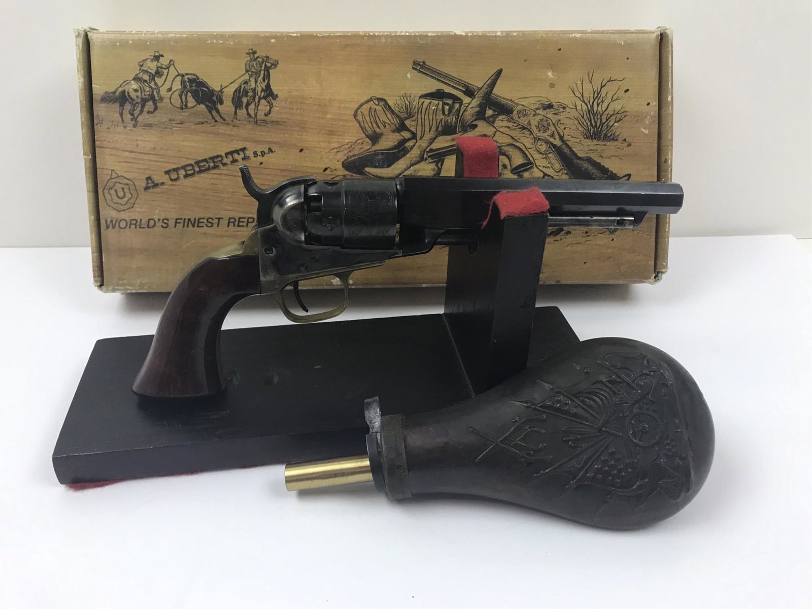 A. UBERTI 1862 POCKET OTT REPLICA: AU - caliber .36 â€“ Mod. 0076 â€“ Barrel 5.5” - S/N A62861 in original box, includes Colt style powder flask is made of copper -features a flag and cannon scene with a spring-lever to