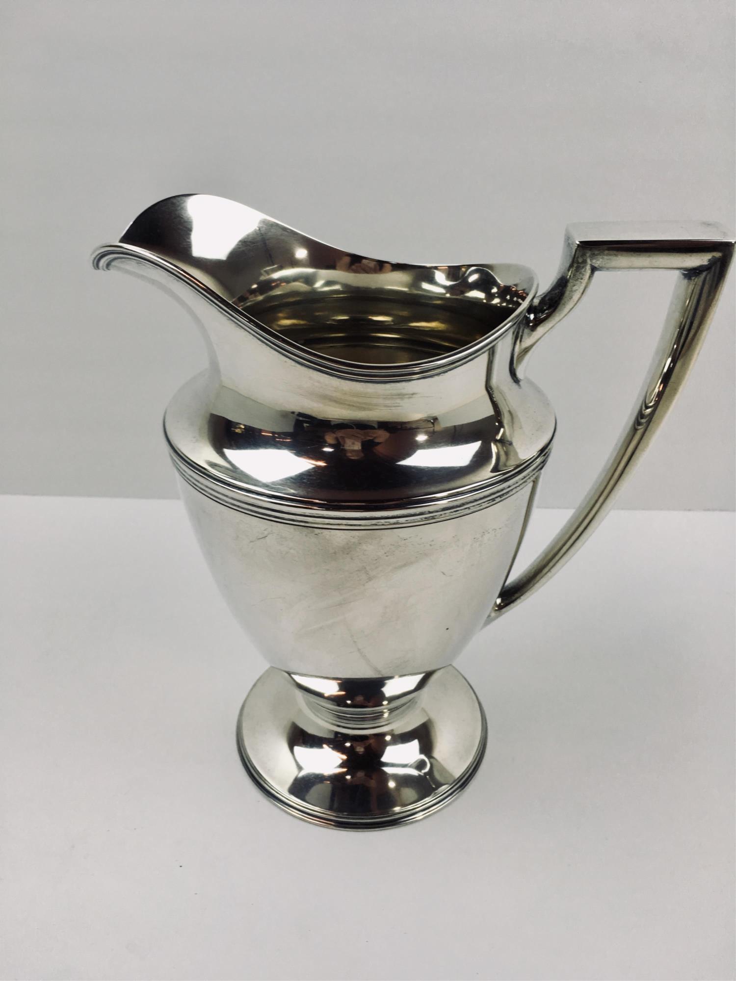 TIFFANY & CO. STERLING SILVER WATER PITCHER: Present mark used since 1938 on bottom - Tiffany & Co. Makers Sterling Silver 18181 M with a star underneath 4 pints - 9 3/8" tall - no monogram or dents - minor surface scratches - weighs 1053g