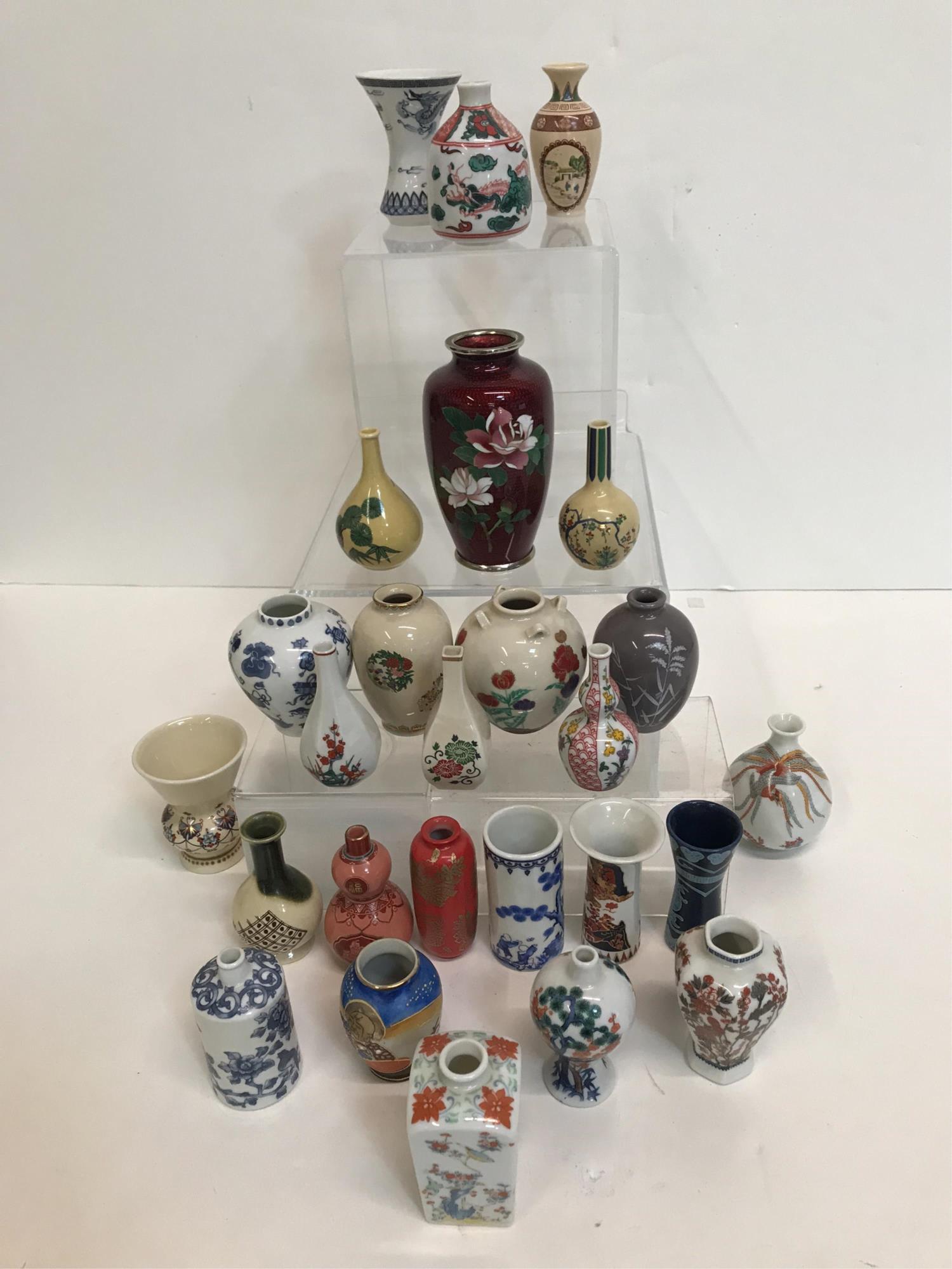 26 PCS MINIATURE BUD VASES & DISPLAY SHELF: One vase is paint and gold decorated with bodhisattva figure with "Made in Occupied Japan" on the bottom measuring approx. 2.5" x 1.75"- 22 miniature bud vases have sticker on the bottom that reads FP