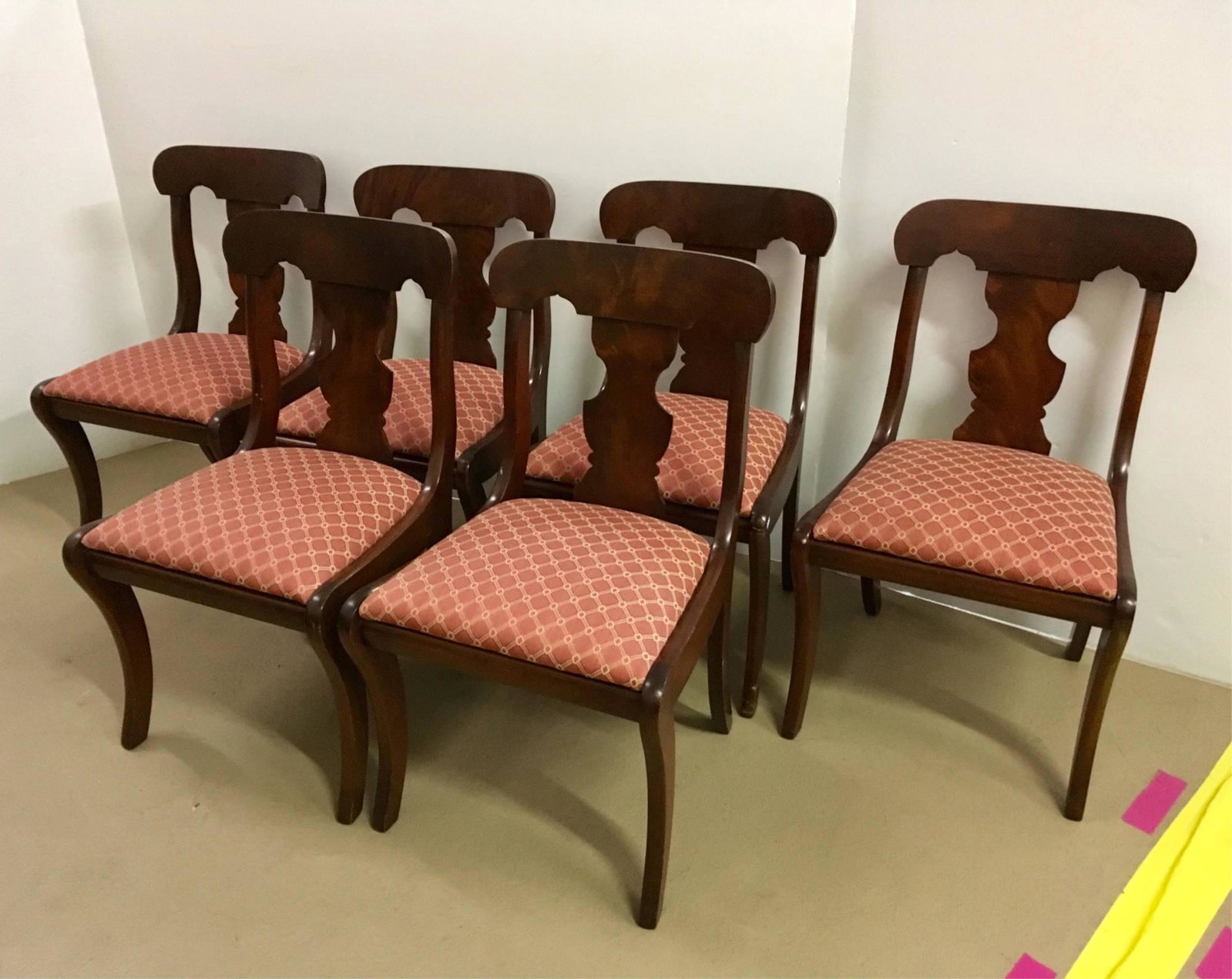 SIX EMPIRE STYLE DINING ROOM CHAIRS: Flamed mahogany fiddle back chairs with saber legs - 20th C