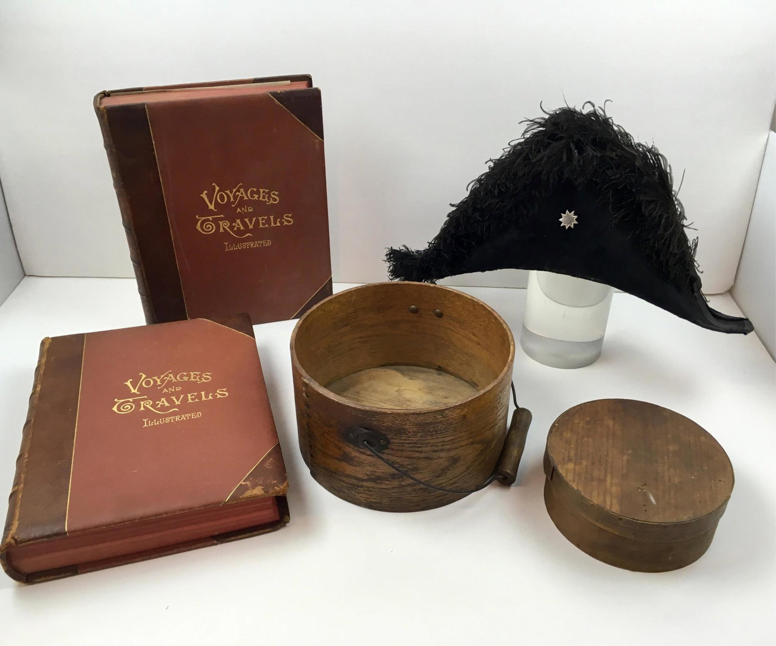 ANTIQUE BOOKS, BICORN HAT AND BOXES: Volumes I and II of Voyages and Travels Illustrated W. W. Walker & Co. 1887, round oak box with bail handle 9" diameter x 5.25", round lidded wooden cheese box 6.5" x 2.75", vintage Freemason Masonic 