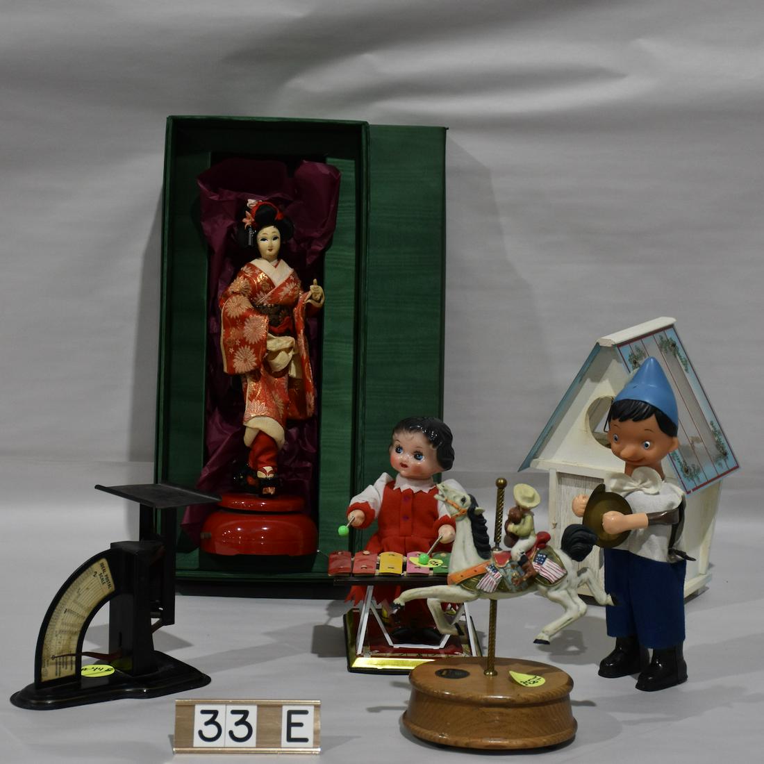 Group of Musical toys: Bird box, Antique Ideal Postage scale, Contadi Castaldi musical doll in original box, Geisha Girl, plus 3 more