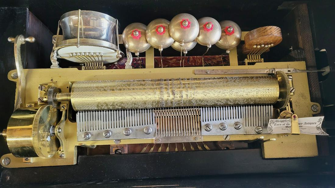 Orchestral Cylinder Musical Organ Box: The organ box has 6 bells, castanet and drum. 14-1/4" cylinder. Inlaid musical instrument on top and front. No broken teeth