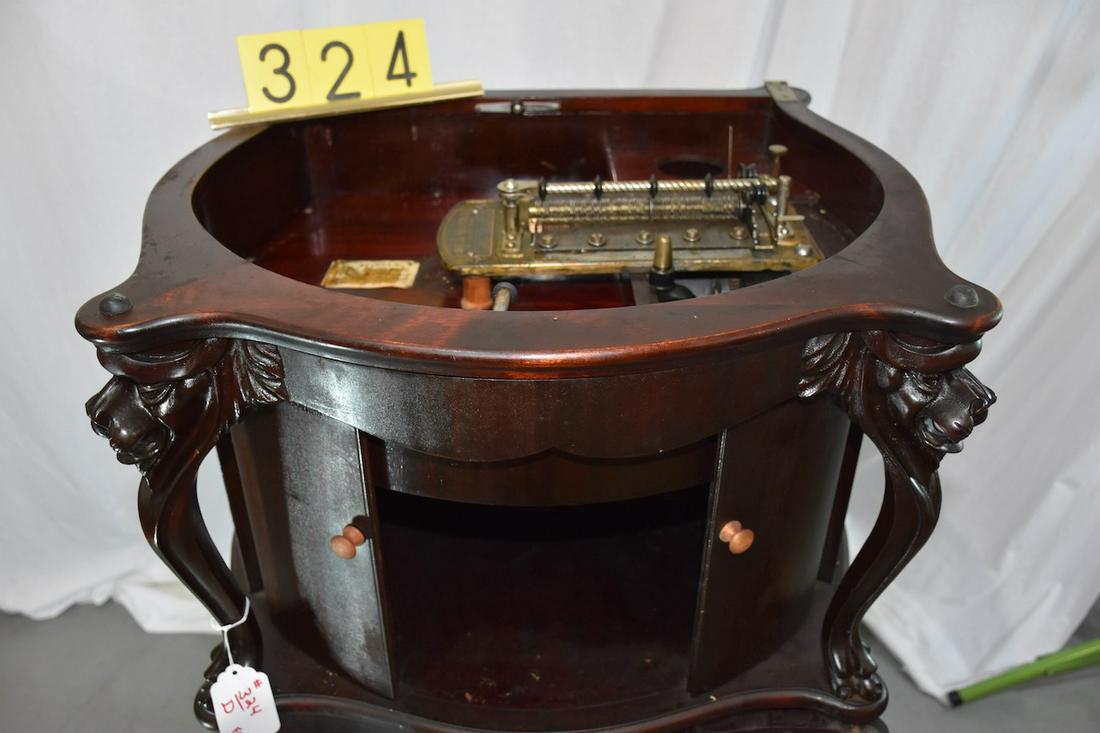 Combination Columbia (Reginaphone) Music Box &: Style 240 Lions or Griffin Head Cabinet. Regina 15-1/2" double comb disc music box. Complete with phonograph turntable, etc. The music box plays, it appears as all the parts are there except the crank