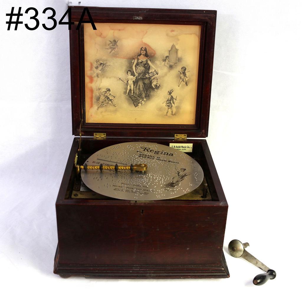 Regina 11" disc music box. Mahogany Case.: Single comb with no broken teeth. Top winding. Regina lithographic in lid. SN-60601