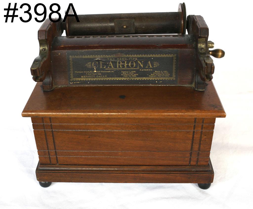 Clariona walnut case Paper roll organ: Patent June 26, 1883