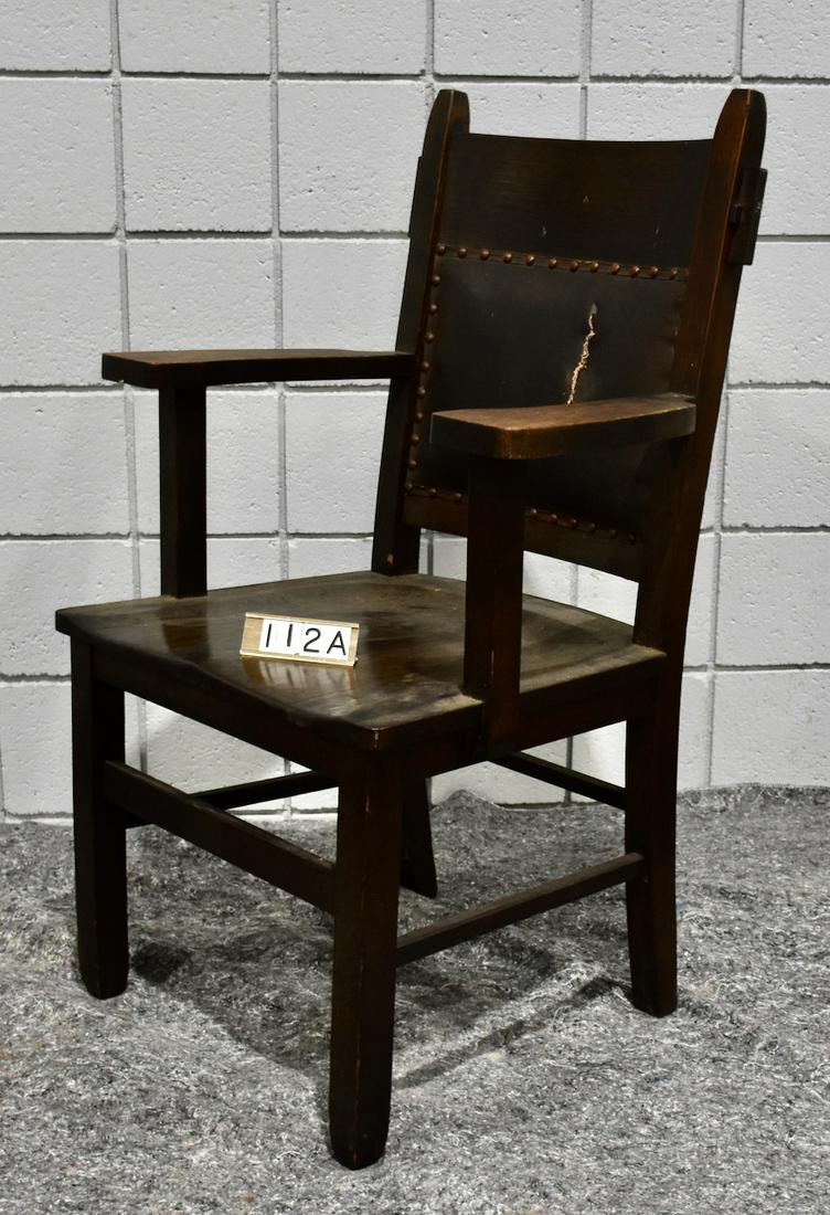 Johnson Arts and Crafts Arm Chair: 40" tall x 22" wide x 18" deep. Solid seat and leather tacked back. Paper label from the manfucturer in Chicago, Illinois