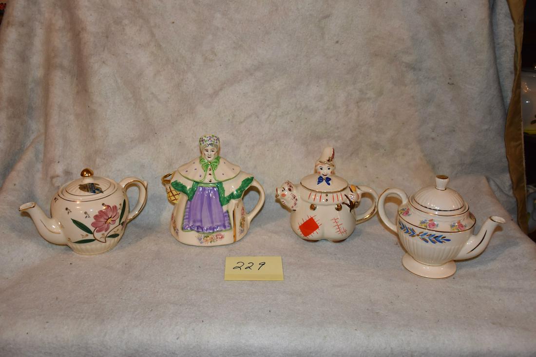 Group of Shawnee Teapots, etc.: Tom Pitcher or teapot with gold trim, Granny Ann teapot with gold trim plus 2 other examples. 9" tall is the tallest