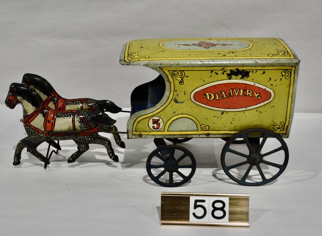 Excellent Tin Horse Drawn Deliver Wagon: 17" long x 8" tall. The delivery wagon is pulled by a team of tin horse. Very good condition. Some paint loss with normal wear