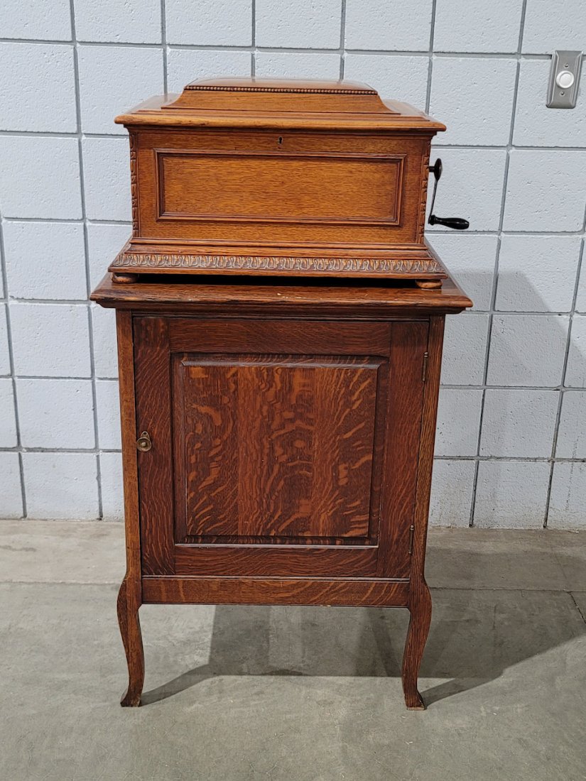 Regina Style 11 Disc Music Box and Base Cabinet: Regina Style 11 Oak 15-1/2\" Disc Music Box and Regina Oak Music Box Base Cabinet. Double Comb with no broken teeth. Includes (13) 15-1/2\" discs. SN-55494. Lyons & Healy, Chicago celluloid dealer tag