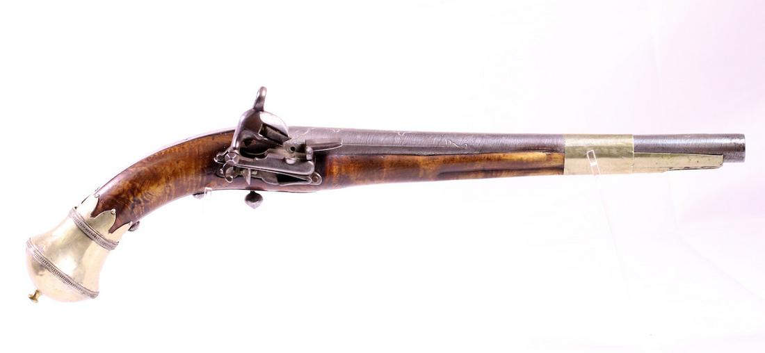 Flintlock Percussion Pistol: Unmarked; Walnut frame; Brass trim; Fancy butt cap with finial in brass; Round metal trigger; 17-1/2" OAL; Arabian style pistol