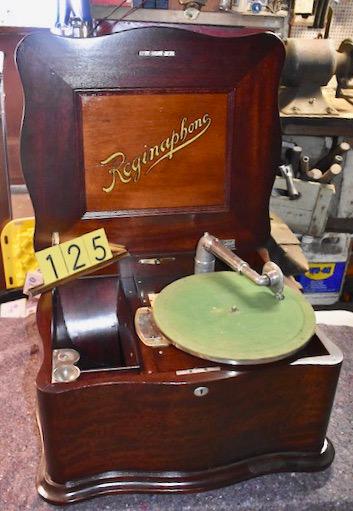 Reginaphone Disc Phonograph/Music Box: Mahogany case. Plays a 15-1/2" disc. Plays well. Serpentine case. Double comb with no broken teeth. Has turntable, tonearm and reproducer for the phonograph operation. Inside horn. 10 Discs included.