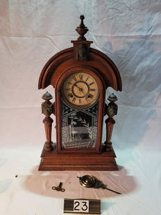 Shelf Clock: Made by the Ansonia Clock Company. Needs to be reglued. Measures 24" tall x 13-1/2" wide.