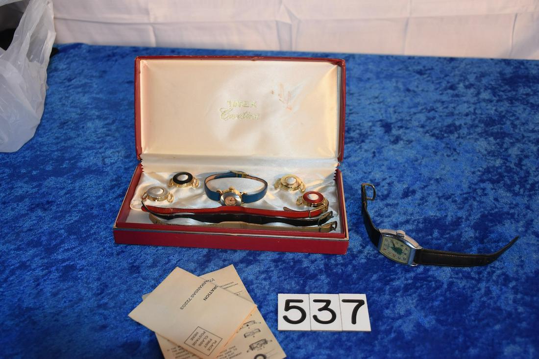Pair of Wrist Watches: The man's is an Ingraham "Civic Construction Corp", Ladies is a Timex Cavatina Set with 5 different bezels and 4 different bands, original box and papers