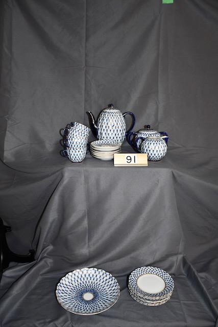 Russian China Tea & Dessert Set: Marked Made in USSR. The blue and white set including the teapot, 6 dessert plates, 6 cups and sauders, cream and sugar, and bowl. Blue and white pattern.