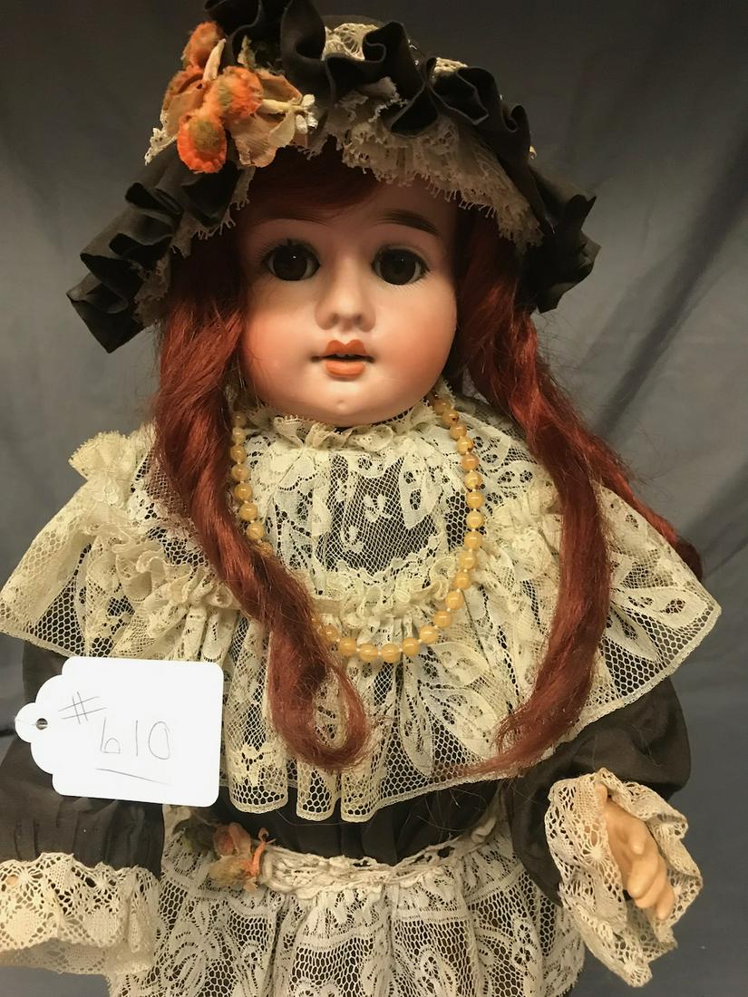 A & M Bisque Doll: Made in Austria. Stationary eyes, open mouth with teeth. Composition body, bisque head. Measures 20" long.