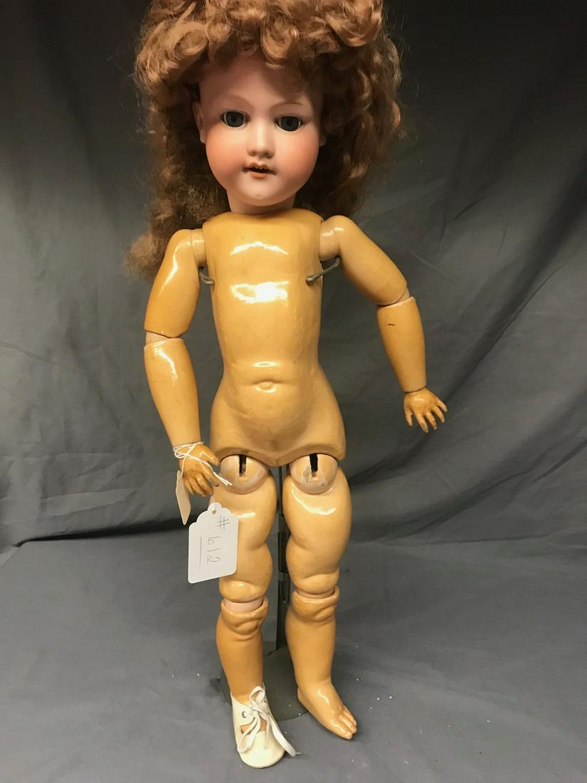 A & M Bisque Head Doll: Marked 390. 26" long. Composition body, stationary eyes. Open mouth with teeth.