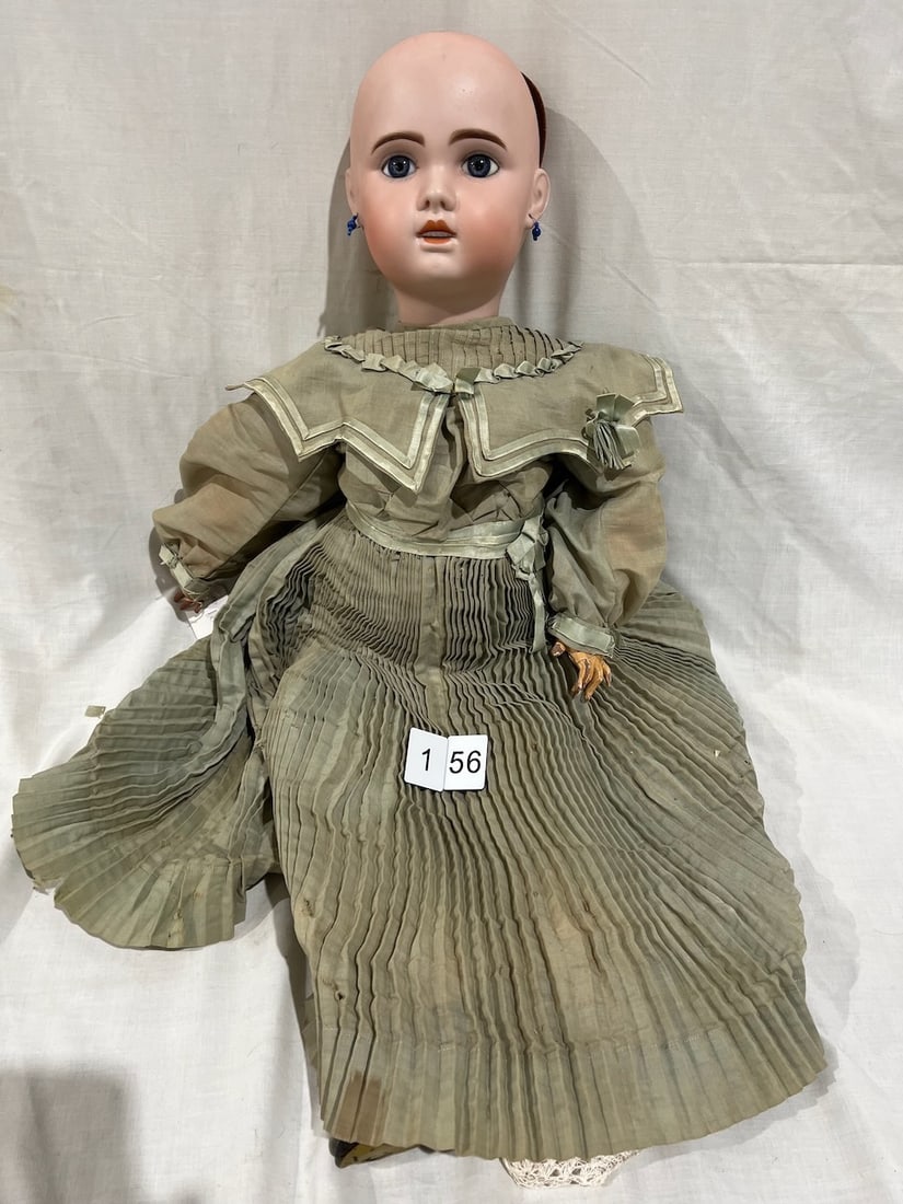 Antique Bisque Doll: The body has a tag decal "AU DEFI, Marseille". Glass eyes, OM with teeth, pierced ears. 31" (some paint loss to hands). No wig