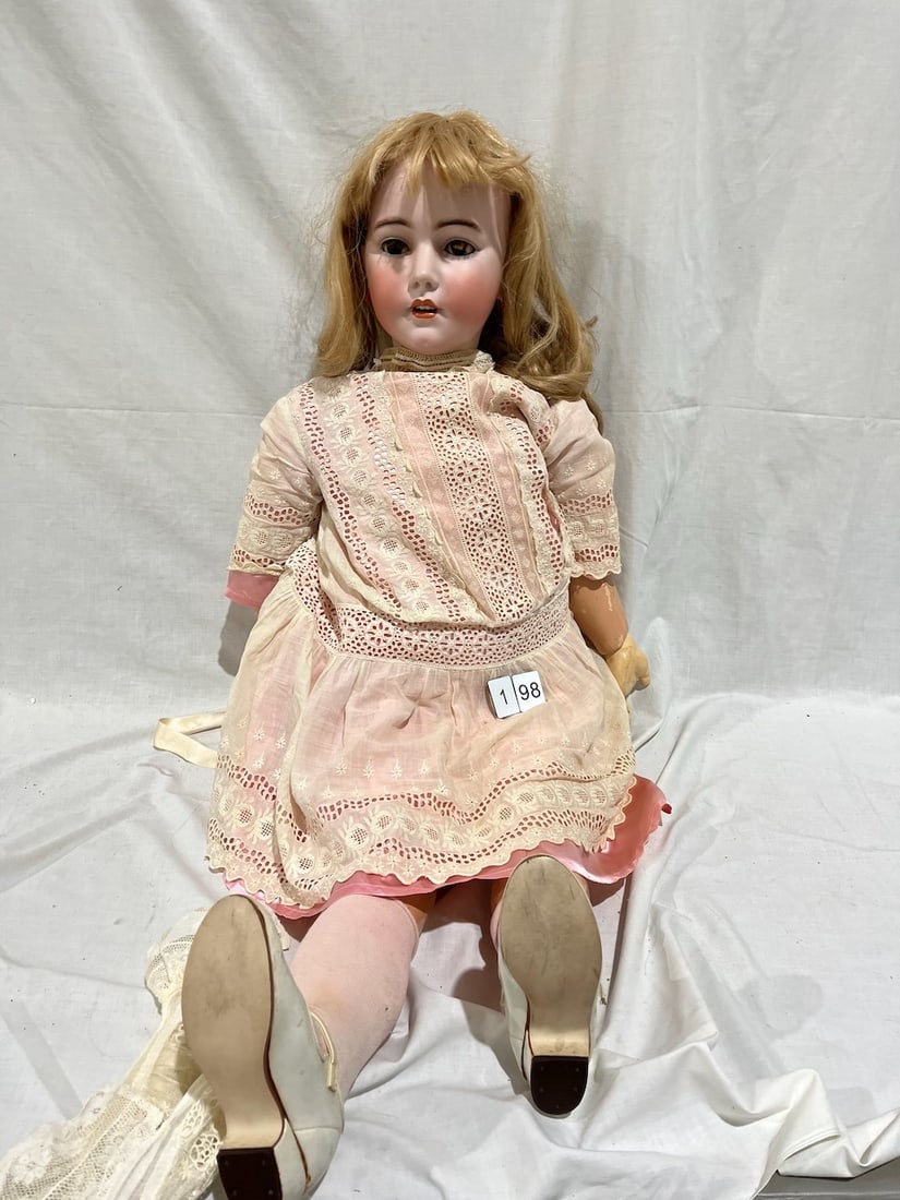 Large Simon & Halbig Bisque Doll: Marked 1018 (?) Germany. 18 S&H Simon & Halbig. OM with teeth, pierced ears, glass eyes. 40" tall. Jointed composition body (replaced knee joint)