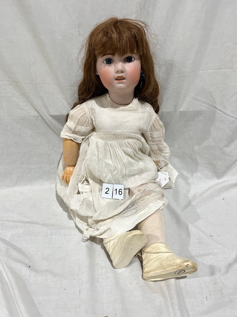 Antique Bisque Doll: 1907. 14. Glass eyes; OM with teeth, pierced ears; jointed composition body. 31"