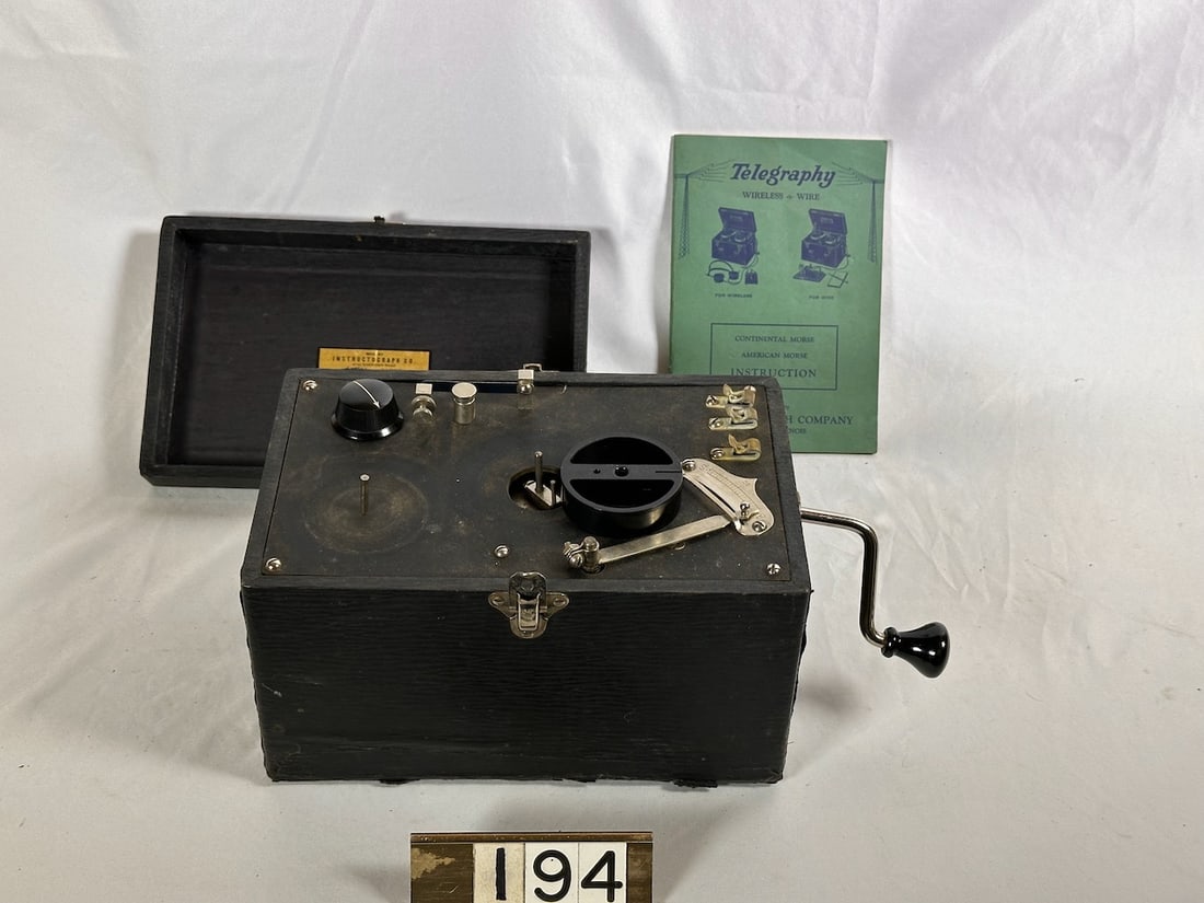 Telegraphy Machine with book: Wireless and/or Wire. Has crank.