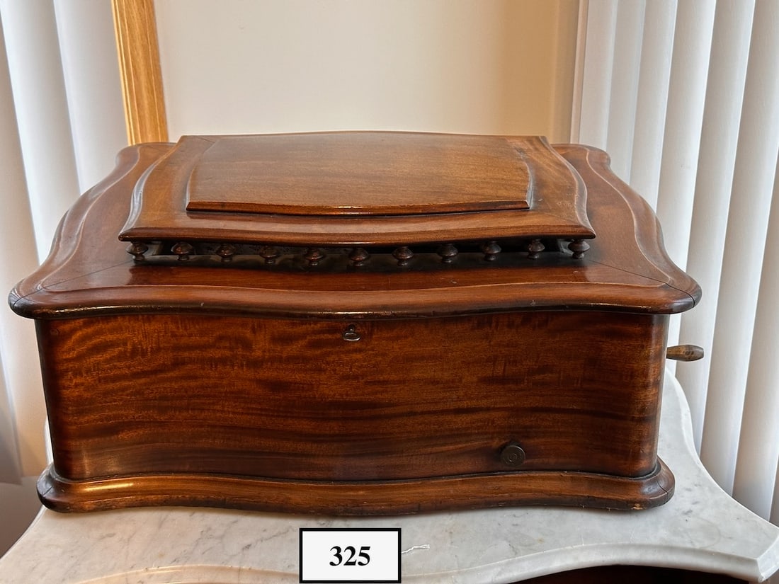 Reginaphone Style 139 with Cupola Top: This combination Music Box and Phonograph plays a 20-3/4" disc. Mahogany Serpentine case, 12 discs with machine, no turntable, tonearm, reproducer or horn. SN-3900268