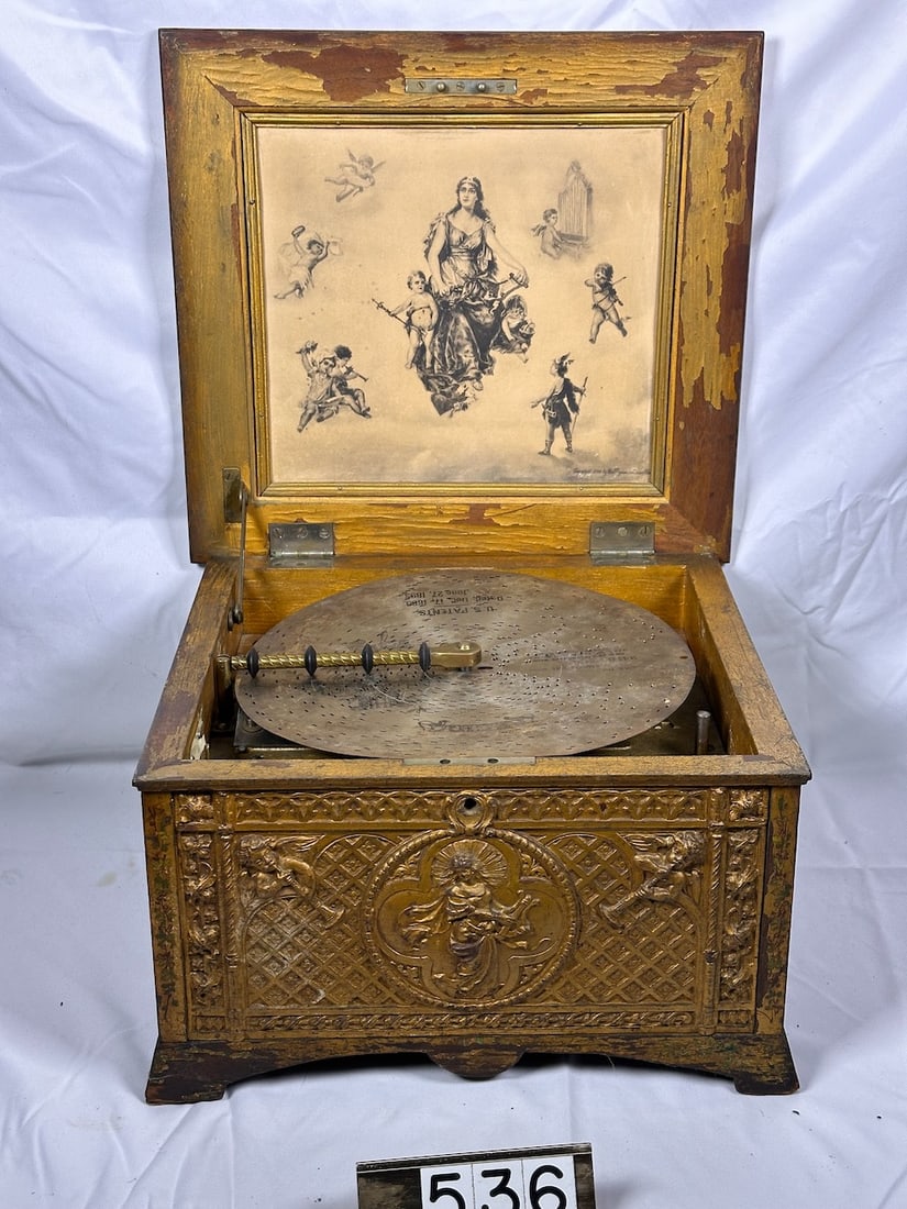 Regina Heavily Carved and Painted Case Music Box: Painted gold case, carved and scenic panels. Double comb with no broken teeth. 11" with one disc.