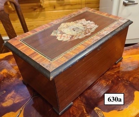 10 Tune Cylinder Music Bell Box: No broken teeth, original tune card, 3 saucer bells with butterfly strikers, tune indicator. The case shows wear.