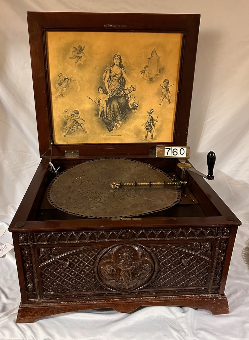 Excellent Regina Carved Case Disc Music Box Style 9: The larger variety oak case. Plays a 15-1/2" disc with 4 discs. Double comb with no broken teeth. Has crank