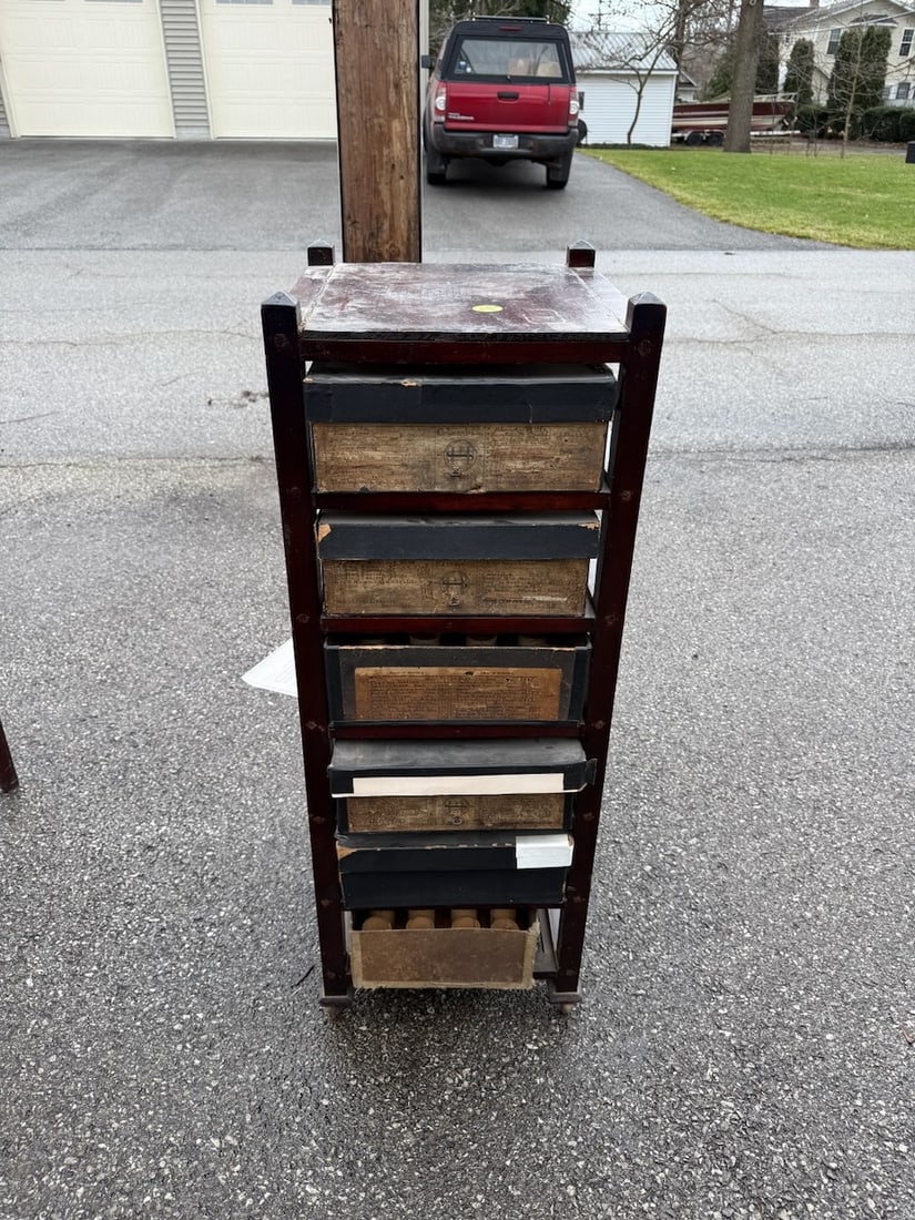 An excellent display of Record boxes: The wood shelving holds the Hawthorne and Sheble pegged record boxes with most still bearing the end decals listing the same. Mahogany finish on the stand