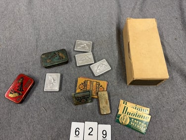 Group of needle packets and tins