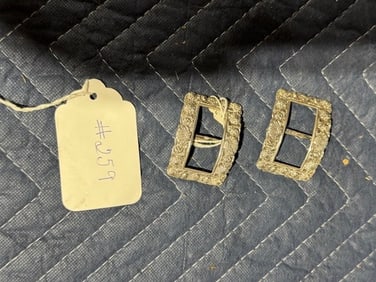 A pair of Silver Embossed Buckles