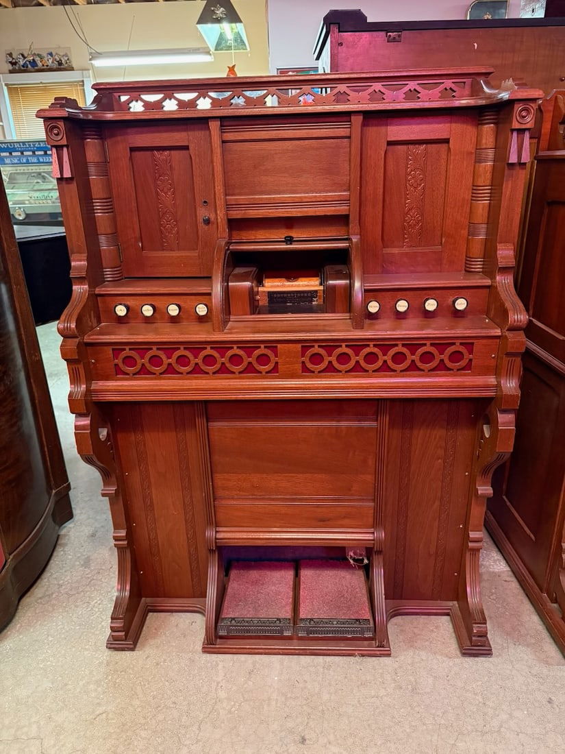 Orchestrone by M Gally: Walnut case upright player organ. The floor model unit is untested. No rolls. Plays a 5" paper roll. ‘This Lot must be picked up in Fordland, MO on September 28 & 29’
