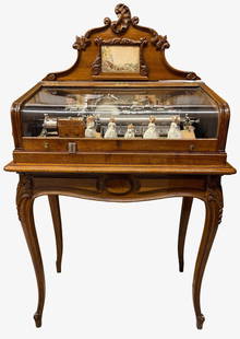 Musique Automatique Station Box: Coin Operated. The mechanism contains 5 dancing dolls, plays 6 tunes with tune card in the gallery, drum and 6 bells with butterfly strikers. The case is also fantastic with a curved glass cover.