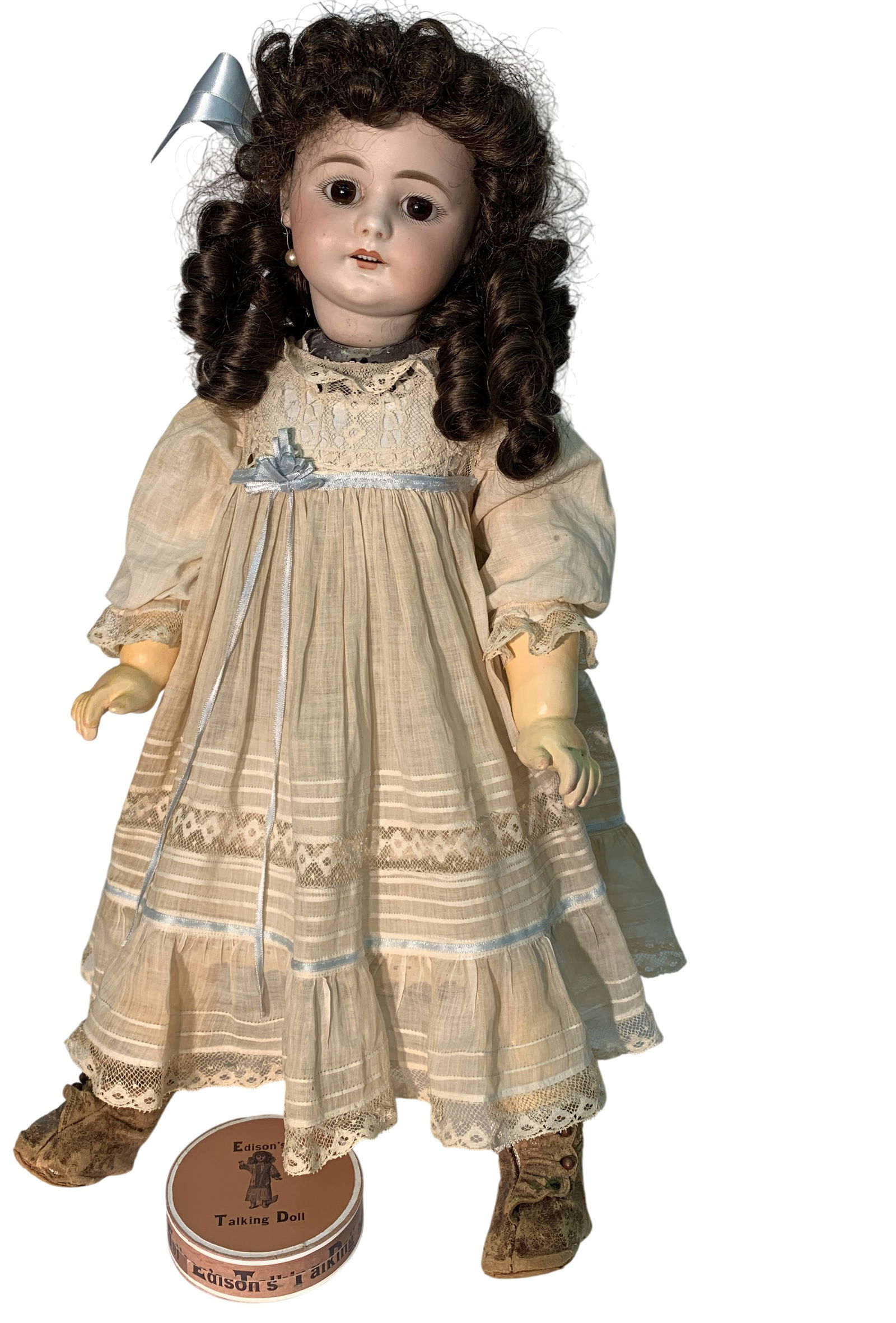 Edison Phonograph Talking Doll: Simon Halbig bisque doll. Metal body housing the original Edison motor. Includes one record and a brass stand. The doll is 22.5" long