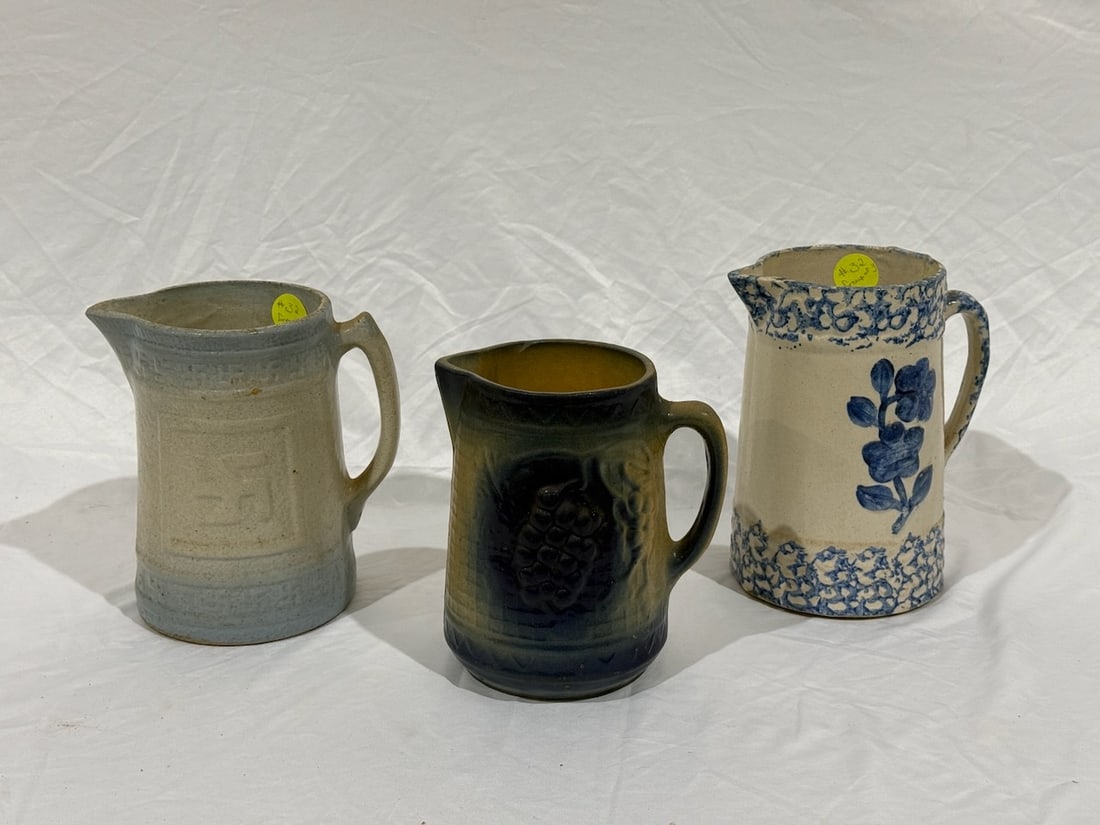 3 Stoneware Pitchers: Floral, Grape and Good Luck Insignia; tallest is 9"