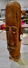 A large carved figure similar to a Totem Pole