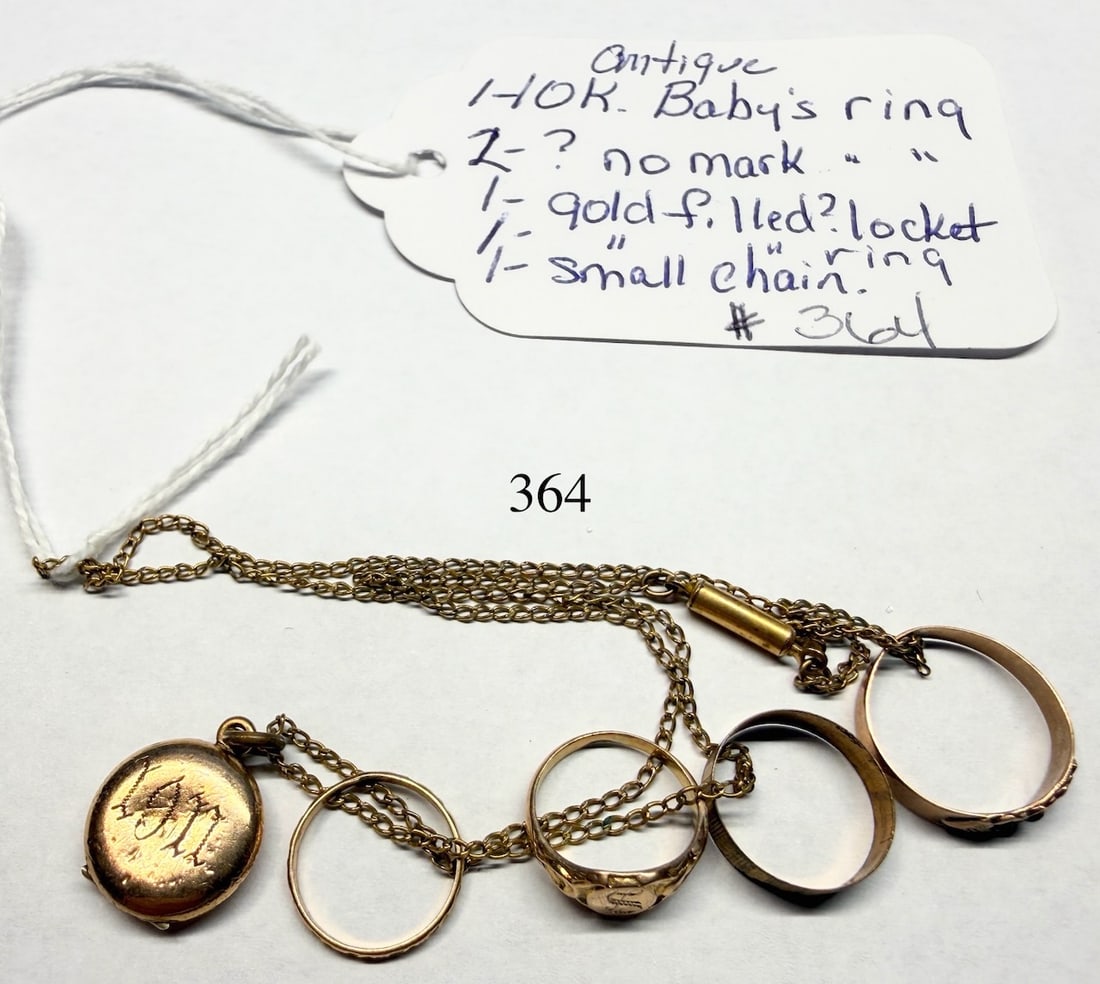 Small Group of Rings and Locket: (4) Baby Rings - (1)10k, (1) G.F. and (2) no mark, locket and small chain.