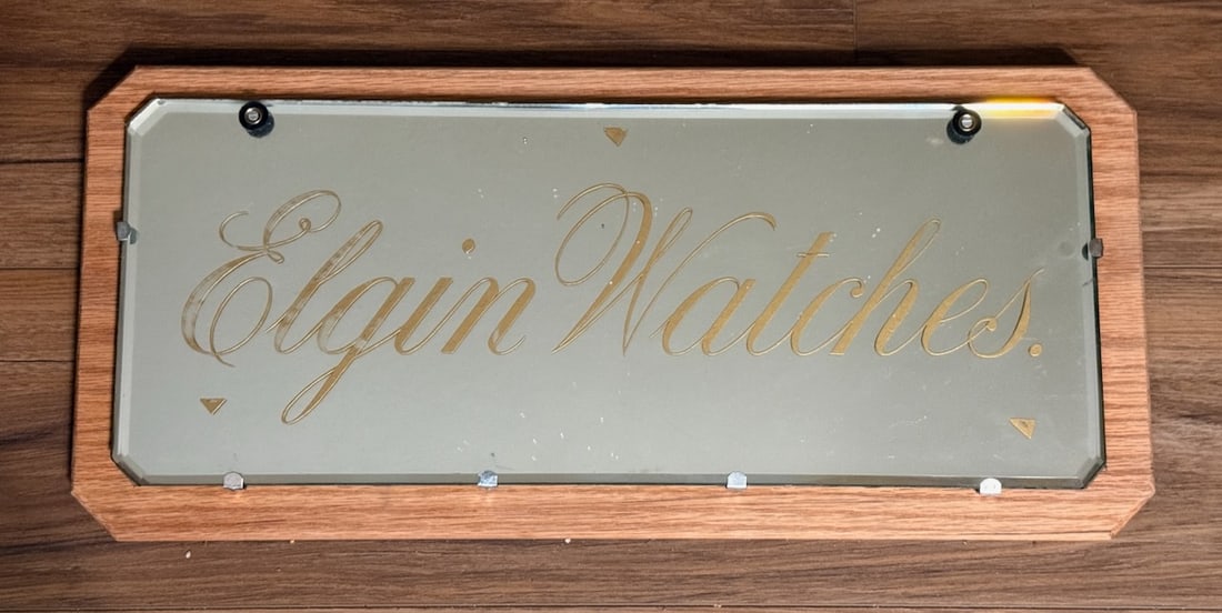 Elgin Watches Heavy Beveled Advertising Mirror.: Mirror measures 20" x 8". Mounted on oak board.