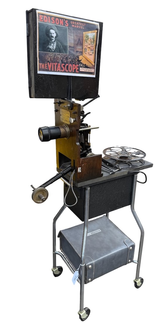 Edison Projecting Kinetoscope: Brass plate. Modern lens, Missing back cover. This with a modern cart with used by Don Gfell for demonstrations