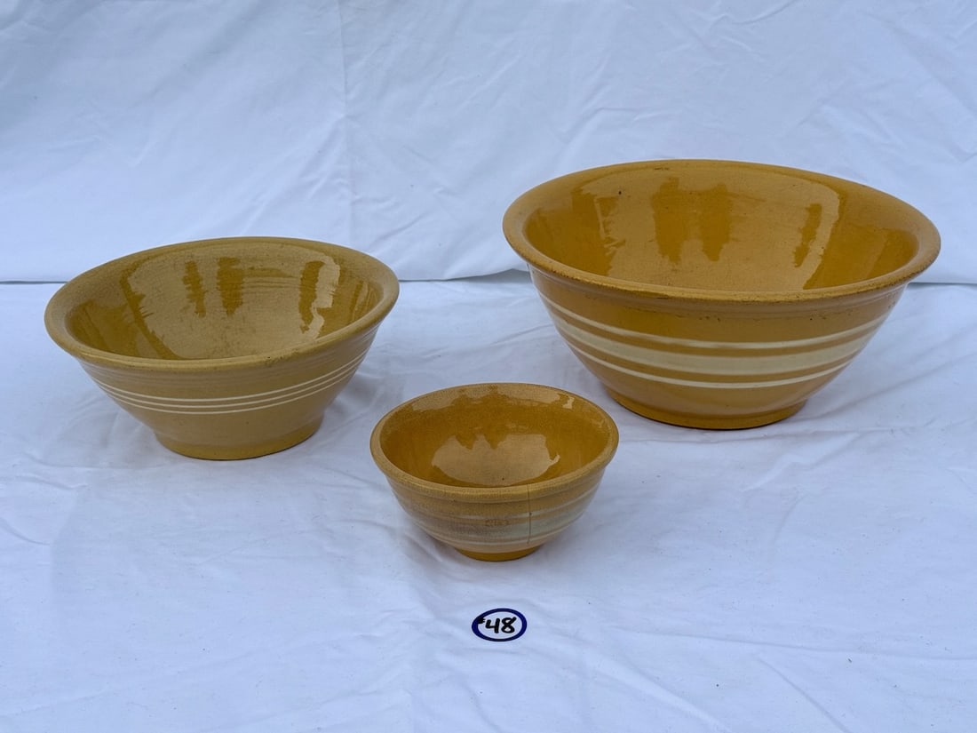 3 Yellow Ware Bowls: Largest is 12" has chip on lip; smallest has hairline crack