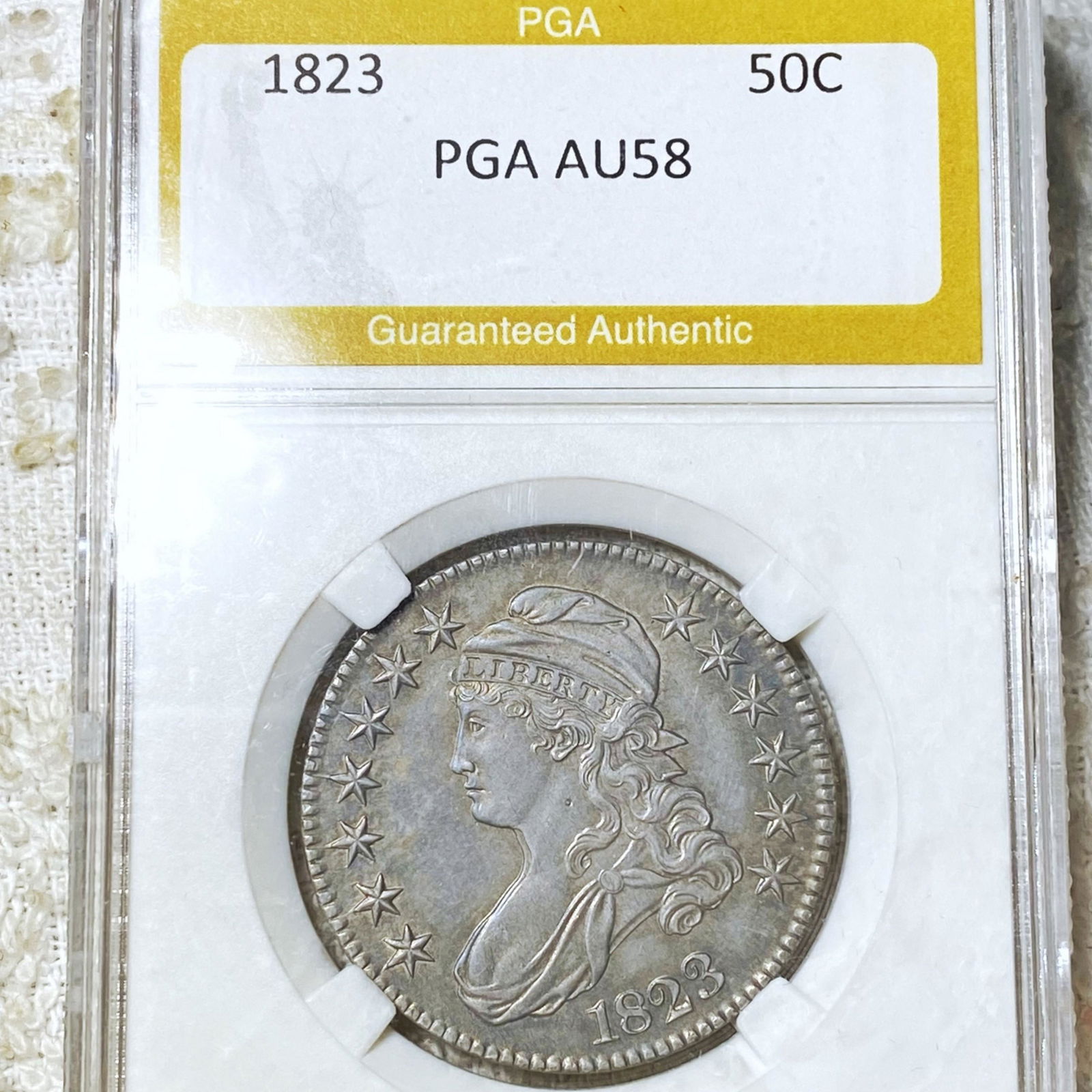 1823 Capped Bust Half Dollar PGA - AU58 (1 of 2)